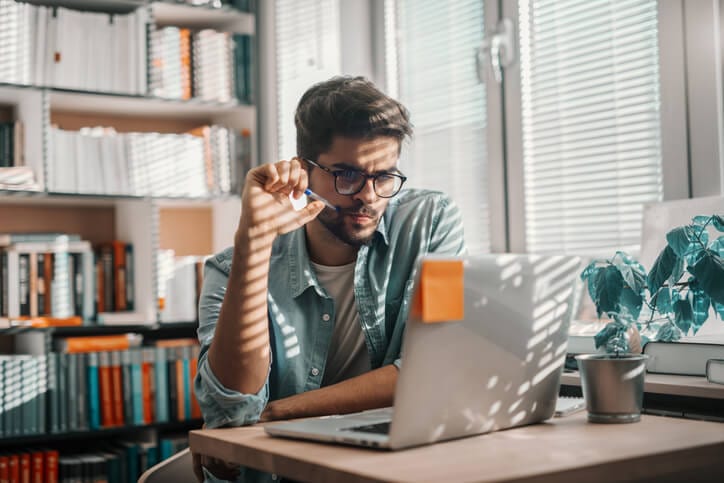 Man Reading On Laptop