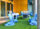 Blue rocking chairs on fake grass