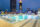 Pool at night with active fountains on